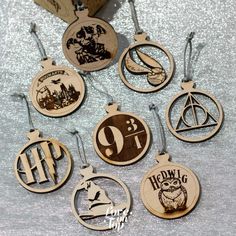 harry potter christmas ornament collection on table with silver glittered background and wooden box