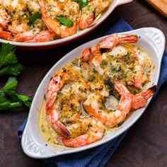 two white dishes filled with shrimp and cheese