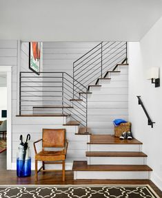 a living room filled with furniture next to a stair case