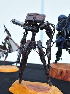 some kind of robot standing on top of a wooden stand