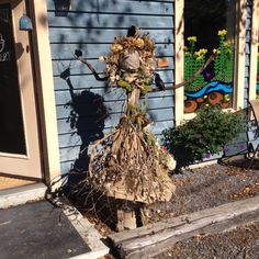 there is a scarecrow standing in front of the house