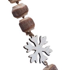 a white snowflake is hanging from a string with wood beads and metal chains