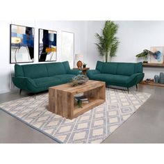 a living room with two couches, a coffee table and a plant in the corner