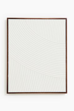 a white wall with a wooden frame on it