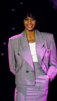 a woman in a purple suit and white shirt