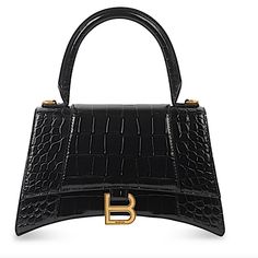 Balenciaga Top-Handle Bag In Crocodile-Embossed Calfskin Leather. Rolled Top Handle. Removable, Adjustable Crossbody Strap (21.6") Flap Top With Hanging "B" Hardware; Snap Closure. Exterior, Slip Compartment At Back. Interior, One Slip Pocket. 5.5"H X 9.1"W X 3.9"D. Made In Italy. Balenciaga Hourglass Bag, Inspired Handbags, Balenciaga Handbags, Eco Bags, Balenciaga Women, Balenciaga Black, Crocodiles, Balenciaga Bag, Chain Crossbody Bag