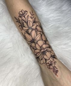 a woman's foot with flowers on it and the bottom part of her leg