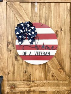 an american flag painted on the side of a wooden door that says, home of a veteran