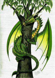 a green dragon sitting on top of a tree