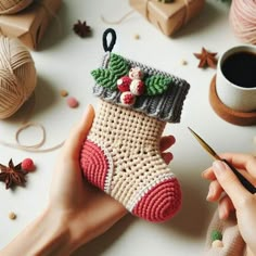 someone is crocheting a christmas stocking ornament