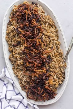 a white plate topped with rice and raisins