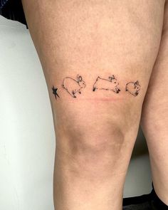 a woman's thigh with three small animals on it