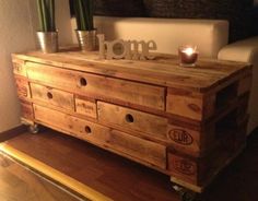 a wooden dresser sitting on top of a hard wood floor next to a white couch