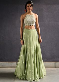 Olive green sequence work gusset skirt paired with pearl encrusted halter neck blouse and tulle dupatta. Embellished Lehenga, Halter Neck Blouse, Halter Neck Blouses, Sangeet Outfit, Green Lehenga, Muted Green, Vacuum Storage, Indian Dresses Traditional, Indian Wedding Wear