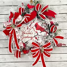 a red and white christmas wreath on a wooden background with the words season's greeting