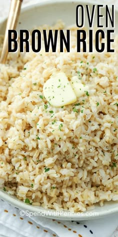 a bowl filled with brown rice and topped with butter