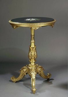 an ornately decorated table with black marble top