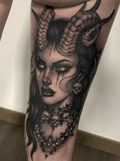 a woman with horns on her head is shown in this tattoo design by the artist