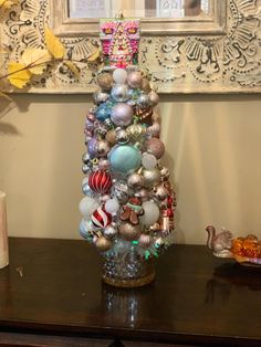 a christmas tree made out of ornaments on a table