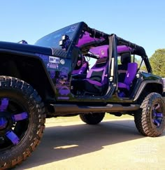 a purple and black jeep with its doors open