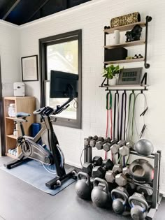 there is a bike and exercise equipment in the room with it's storage rack