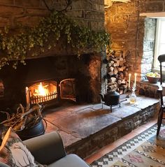 a living room filled with furniture and a fire place in the middle of a stone fireplace