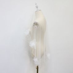 a white mannequin with a veil on it's head is hanging from the wall