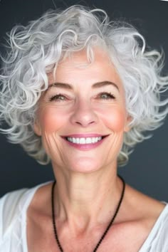 Wispy grown-out white pixie curly hairstyle for women over 60. Curly Hairstyles For 60 Year Old Women, Spiral Perm Short Hair Curly Bob, White Curly Hairstyles, Short Curly Gray Hair Over 50, Curly Gray Hair Over 50 Curls, Chin Length Curly Hair, Curly Bobs For Older Women, Platinum White Hair, Medium Curly Bob