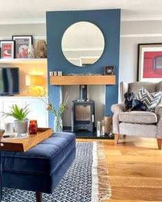 a living room filled with furniture and a fire place next to a mirror on the wall