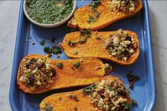 three delicacy stuffed sweet potatoes on a blue tray