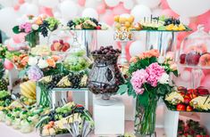 a table topped with lots of different types of fruits and veggies on display