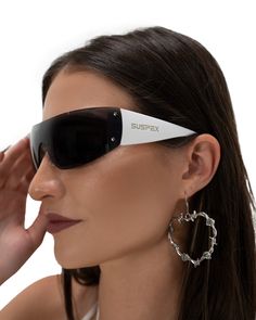 Embrace futuristic rave vibes with our Black and White Shield Sunglasses. These Y2K-inspired shades boast rimless lenses in a sleek wrap-around design, a perfect accessory for any rave outfit to standing out under neon lights. SUSPEX engraved white acetate frame Non-polarized UV Protection coating Lens width: 165cm Lens height: 45cm SUSPEX dust bag included Techno Sunglasses, Rave Style Plastic Sunglasses With Uv Protection, Futuristic Black Sunglasses With Uv Protection, Black Anti-reflective Rave Sunglasses, Subversive Sunglasses, Rave Outfit, Shield Sunglasses, Shield Design, Y2k Style