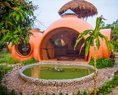 an orange building with a pond in front of it