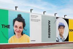 a large advertisement on the side of a building with people's faces painted on it