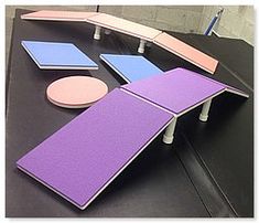 a table with several pieces of furniture on it, including a ping pong paddle