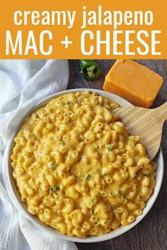 macaroni and cheese in a white bowl with a wooden spoon next to it