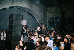 a large group of people standing in front of a stage