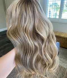 Our colorist line will be full of one-of-a-kind colors, hand-dyed by one of our top US colorists. They are perfection! Color Descriptions - natural looking blonde with level 7 root, warm and neutral lowlights throughout.  • Cap Construction: Lace Front Cap • Cap size: Medium 22”-22.5” • Length: 22” • 130% density • Slightly bleached knots *Please be aware that our colorist collection is not eligible for any discounts*    Disclaimer ** Our colorist created wigs, skillfully designed by our talented colorists, are exquisite works of art. Each piece is thoughtfully processed to achieve the unique, custom look you desire. However, it's important to note that due to the bleaching process involved, there may be occasional drawbacks - The lifespan of these wigs is shorter compared to regular human Dirty Blonde Wavy Hair, Ashy Dark Blonde Balayage, Natural Looking Blonde, Dark Blonde Balayage, Color Descriptions, Blonde Wavy Hair, Level 7, Colored Wigs, Dirty Blonde