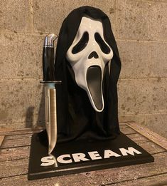 a black and white scream mask with a knife