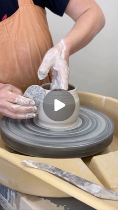 a person is making a pot on a potter's wheel