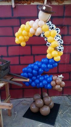 a bunch of balloons that are in the shape of a horse on top of a table