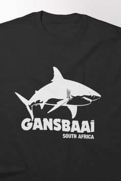 a black t - shirt with an image of a shark and the words, cansbaai south africa