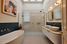 a large bathroom with two sinks and a bathtub in it's center area