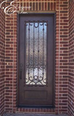 the front door to a brick house with wrought iron bars on it and a glass window