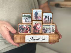 a person holding a wooden block with photos on it and the words memories written in black