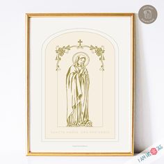 an image of the virgin mary in gold framed on a white wall next to a plant