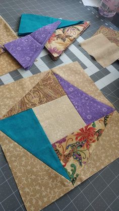 several pieces of fabric laid out on the floor to be quilted into placemats