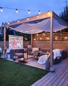 an outdoor living area is lit up with string lights