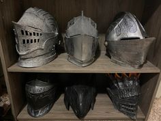 three different types of helmets sit on a shelf