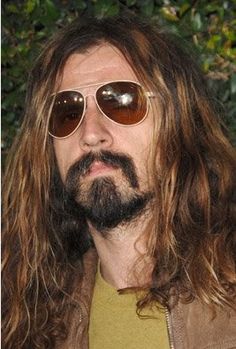 a man with long hair and sunglasses on